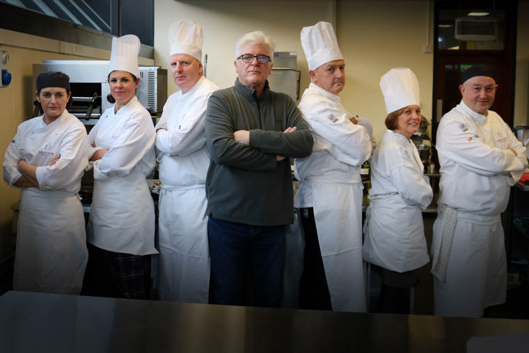 The competing teams get ready for the ‘SRC Cook Off’ challenge. (L-R) Lynnette McMath (SRC Level 3 Professional Cookery Lecturer), Emma Marmion (Newry Chamber of Commerce & Trade President), Brian Doran (SRC Chief Executive), Kevin McAllister (Downtown Radio Presenter and Event Compere), Raymond Sloan (SRC Director for Client Services), Beverley Harrison (Further Education Director, Department for the Economy) and Adrian Fitzpatrick (SRC Level 3 Professional Cookery Lecturer) The competing teams get ready for the ‘SRC Cook Off’ challenge. (L-R) Lynnette McMath (SRC Level 3 Professional Cookery Lecturer), Emma Marmion (Newry Chamber of Commerce & Trade President), Brian Doran (SRC Chief Executive), Kevin McAllister (Downtown Radio Presenter and Event Compere), Raymond Sloan (SRC Director for Client Services), Beverley Harrison (Further Education Director, Department for the Economy) and Adrian Fitzpatrick (SRC Level 3 Professional Cookery Lecturer)